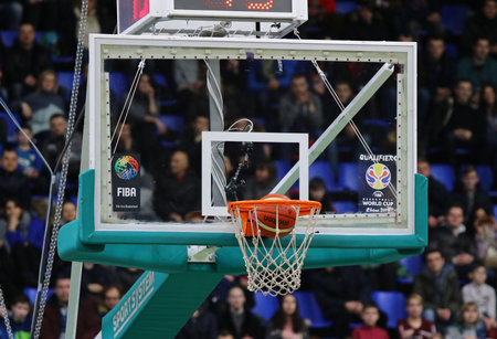 KYIV, UKRAINE - FEBRUARY 26, 2018: Ball inside the basket during FIBA World Cup 2019 European Qualifiers basketball game Ukraine v Sweden at Palace of Sports in Kyivのeditorial素材