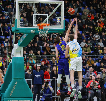 KYIV, UKRAINE - FEBRUARY 26, 2018: Artem PUSTOVYI of Ukraine (R) scores during FIBA World Cup 2019 European Qualifiers game against Sweden at Palace of Sports in Kyiv. Ukraine won 77-66のeditorial素材