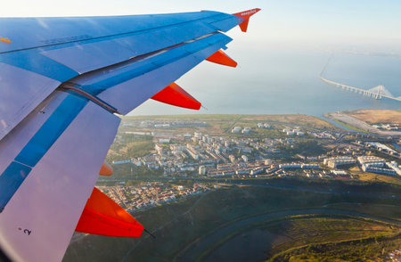 LISBON, PORTUGAL - JUNE 14, 2013: Airbus A320 operated by EasyJet (flight number EZY 7603) flights over Lisbon city. Aerial view through the airplane windowのeditorial素材