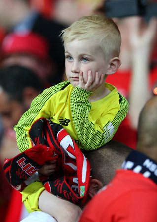 KYIV, UKRAINE - MAY 26, 2018: Young Liverpool supporter reacts after his team lost the UEFA Champions League Final 2018 game against Real Madrid at NSC Olimpiyskiy Stadium in Kyiv. Real Madrid won 3-1のeditorial素材