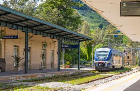 ENNA, ITALY - MAY 9, 2018: Train arrives to Enna railway station (Stazione di Enna), small railway station situated in 5km away well below the Enna old town, Sicily, Italyのeditorial素材