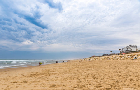 People enjoying the windy summer day at the beach on the Atlantic coast of France near Lacanau-Ocean, Bordeaux, Franceのeditorial素材