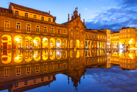 Exterior night view of Arcada (or Largo da Arcada) and the Church of Lapa (Igreja da Lapa), reflected in the fountain on Republic Square (Praca da Republica) in Braga, Portugalのeditorial素材