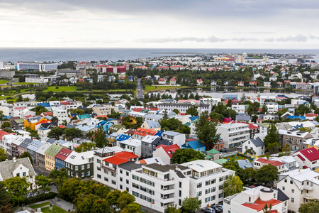 Picturesque aerial view of Reykjavik city, Iceland. Downtown, mountains and ocean scenery beyond the city. View from the top of Hallgrimskirkja Cathedral in Reykjavikのeditorial素材