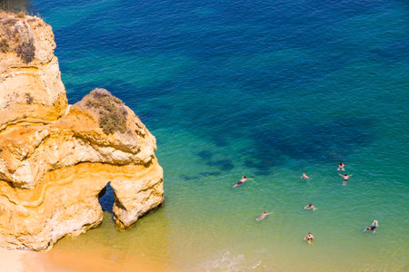 Aerial top view of Praia do Camilo beach in Lagos, Algarve region, Portugal. Praia do Camilo is one of the best beaches in Lagos. Famous for the crystal clear water and impressive cliff formationsのeditorial素材