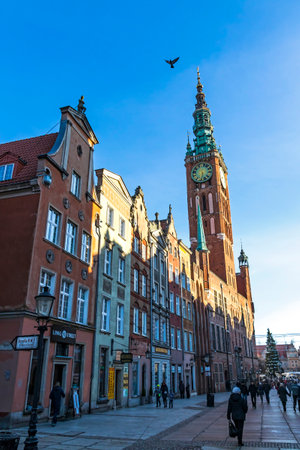 GDANSK, POLAND - DECEMBER 3, 2016: People walk along the Long Street (Dluga) in Gdansk old town, Poland. Tower of Gdansk Town Hall on the background. Winter sunny day. Christmas timeのeditorial素材