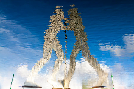 BERLIN, GERMANY - FEB 25, 2015: Molecule Man sculpture reflected on Spree River in Berlin. Designed by Jonathan Borofsky, dedicated to the unity of 3 districts: Friedrichshain, Kreuzberg and Treptowのeditorial素材