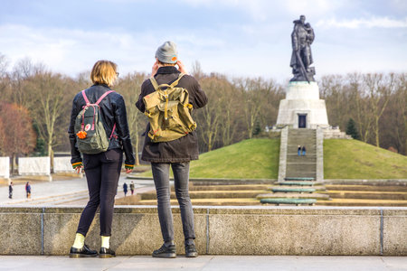 BERLIN, GERMANY - FEBRUARY 25, 2015: Two teenagers view the Soviet War Memorial in Treptower Park in Berlin. Central war memorial of East Germanyのeditorial素材