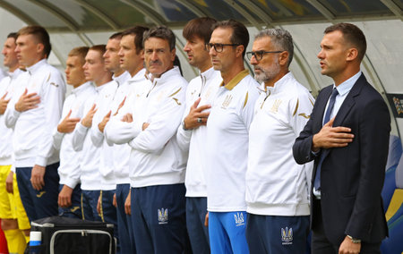 LVIV, UKRAINE - SEPTEMBER 9, 2018: Ukrainian coaches and bench players listen to the National Anthem before the UEFA Nations League game Ukraine v Slovakia at Arena Lviv stadium in Lviv, Ukraineのeditorial素材