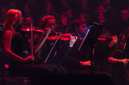 KYIV, UKRAINE - NOVEMBER 22, 2018: Violinists of Symphony Orchestra (conductor Andrey Chernyi) perform on stage during "The Game of Thrones" concert at National Palace of Arts "Ukraina" in Kyivのeditorial素材