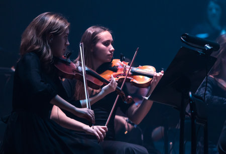 KYIV, UKRAINE - NOVEMBER 22, 2018: Violinists of Symphony Orchestra (conductor Andrey Chernyi) perform on stage during "The Game of Thrones" concert at National Palace of Arts "Ukraina" in Kyivのeditorial素材
