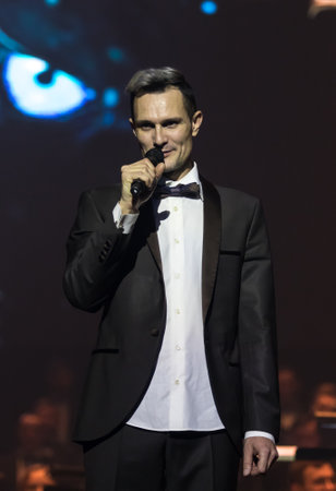 KYIV, UKRAINE - NOVEMBER 22, 2018: Conductor of Symphony Orchestra Andrey Chernyi bows during "The Game of Thrones" concert at National Palace of Arts "Ukraina" in Kyiv, Ukraineのeditorial素材