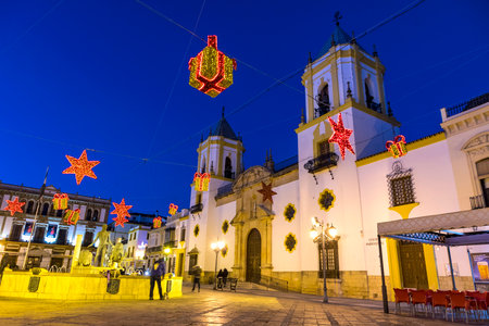RONDA, SPAIN - DECEMBER 13, 2017: Church of our Lady (Iglesia de Nuestra Senora del Socorro) on Plaza del Socorro square illuminated with Christmas holiday decoration, Ronda city, Andalusia, Spainのeditorial素材