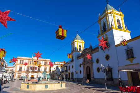 RONDA, SPAIN - DECEMBER 14, 2017: Church of our Lady (Iglesia de Nuestra Senora del Socorro) on Plaza del Socorro square decorated with Christmas holiday decoration, Ronda city, Andalusia, Spainのeditorial素材