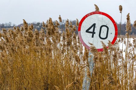 Old speed limit traffic sign on the side of the roadの写真素材
