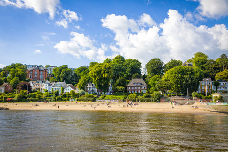 Hamburg, Germany - June 25, 2014: Summer view of the beach (Strand Oevelgoenne) on the Elbe river in Oevelgoenne district of Hamburg city. Popular place by many Hamburgers and touristsのeditorial素材