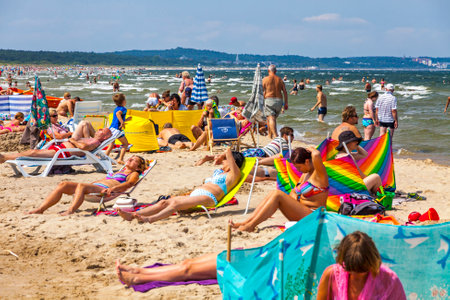 Swinoujscie, Poland - July 7, 2014: People relax on a crowded Baltic sea beach on Usedom island in Swinoujscie city, Polandのeditorial素材