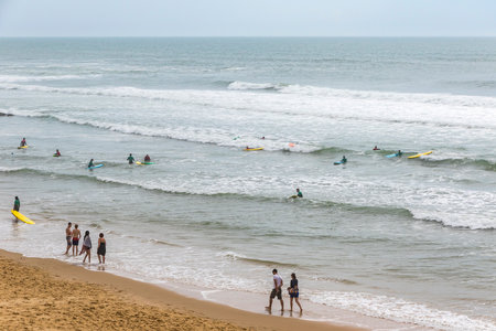 Bordeaux, France - June 13, 2017: Unidentified surfers enjoy waves in the water of Atlantic ocean on the coast near Lacanau-Ocean, Bordeaux, Franceのeditorial素材