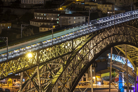 Close-up night view of Dom Luis I Bridge over the Douro river in Porto city, Portugal
