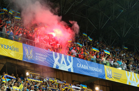 LVIV, UKRAINE - JUNE 7, 2019: Ukrainian supporters burn flares during the UEFA EURO 2020 Qualifying game Ukraine v Serbia at Arena Lviv stadium in Lviv, Ukraineのeditorial素材