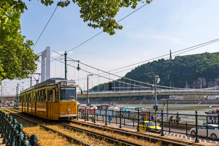 Budapest, Hungary - May 5, 2018: Tram No. 2 moves along Danube river near Petofi ter. Budapest tram network is one of world largest tram networks, total route is over 156km. In operation since 1866のeditorial素材