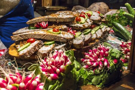 Kiosk on Christmas market with traditional German sandwiches from dark farmhouse breadの写真素材
