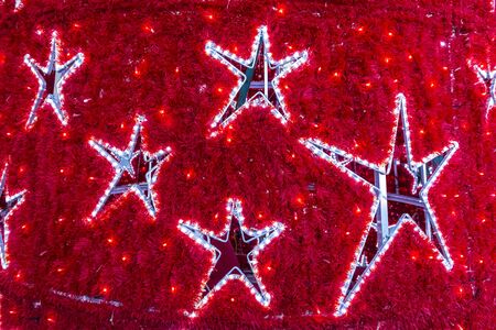 Close-up star shapes on a decorated New Year tree. Details of Christmas holiday decorationsの写真素材