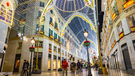 Malaga, Spain - December 10, 2017: People walking on Calle Marques de Larios street, decorated with Christmas decorations. Most popular pedestrian street in Malaga city, Andalusia, Spainのeditorial素材