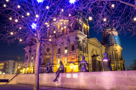 Berlin, Germany - Dec 18,2018: Three Girls and a Boy, life-size statues by sculpture Wilfried Fitzenreiter. Were made in 1977-79, situated on Spree river promenade near Berlin Cathedral (Berliner Dom)のeditorial素材