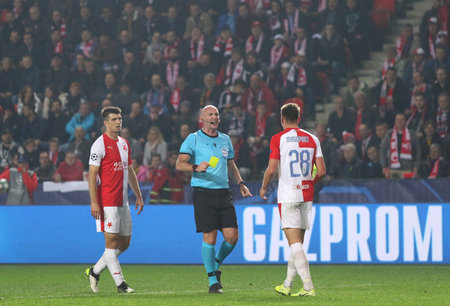 PRAGUE, CZECHIA - OCTOBER 23, 2019: Referee Bobby Madden (SCO) shows yellow card to Lukas Masopust during the UEFA Champions League game Barcelona v Slavia Praha at Eden Arena in Pragueのeditorial素材