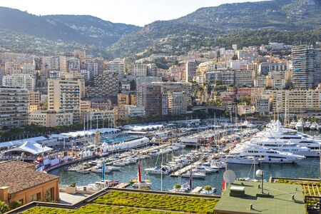 Picturesque view of luxury yachts and apartments in harbor of Monte Carlo, Monaco, French Riviera....