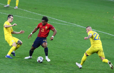 KYIV, UKRAINE - OCTOBER 13, 2020: Adama Traore of Spain (C) fights for a ball with Mykola Shaparenko and Oleksandr Zubkov of Ukraine during their UEFA Nations League game at NSK Olimpiyskiy stadiumのeditorial素材