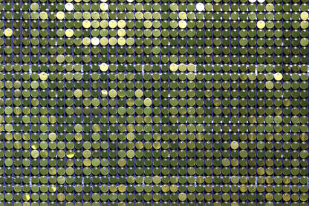 Background sequin. Holiday abstract glitter background with blinking lights. Fashion fabric golden glitter sequins backgroundの写真素材