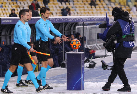 KYIV, UKRAINE - NOVEMBER 23, 2021: Halil Umut Meler (TUR) and assistans Mustafa Eyisoy and Ibrahim Caglar Uyarcan go the pitch before UEFA Champions League game Dynamo Kyiv v Bayern Munchen in Kyivのeditorial素材
