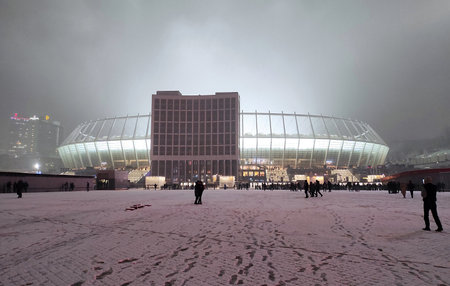 KYIV, UKRAINE - NOVEMBER 23, 2021: Facade night view of NSC Olimpiyskyi stadium in Kyiv seen before the UEFA Champions League game Dynamo Kyiv v Bayern Munchenのeditorial素材