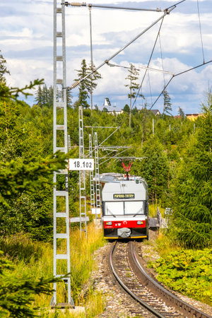 High Tatras, Slovakia - July 2018: Tatra Electric Railways (TEZ-TER) train (also known as "Tatra tram") goes through the forest near Tatranska Polianka stop in High Tatras mountains, Slovakiaのeditorial素材