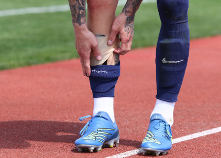 Uzhhorod, Ukraine - April 24, 2023: Oleksandr Nazarenko of SC Dnipro-1 removes the socks and changes...