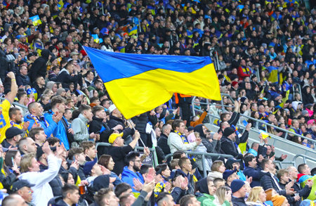 Wroclaw, Poland - March 26, 2024: Ukrainian supporters with flags show their support during the UEFA EURO 2024 Play-off game Ukraine v Iceland at Tarczynski Arena in Wroclaw. Ukraine won 2-1のeditorial素材