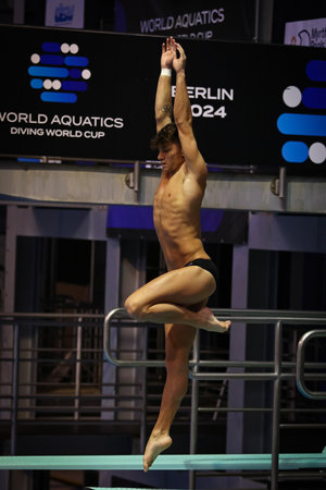 Berlin, Germany - March 22, 2024: Tyler DOWNS of USA performs during Mixed 3m & 10m Team Event Final of the World Aquatics Diving World Cup 2024 in Berlin, Germanyのeditorial素材