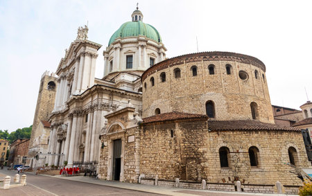 Duomo Vecchio or Old Cathedral (also called La Rotonda), Roman Catholic church in Brescia, Italy. The rustic circular Romanesque co-cathedral stands next to the Duomo Nuovo of Brescia (on background)の写真素材