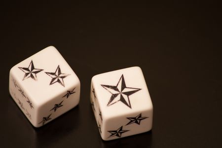 Two dice with stars on black backround
