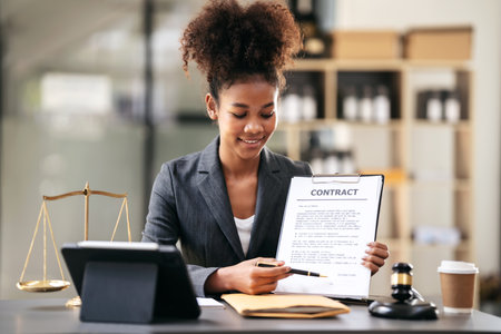 African american lawyer woman in suit pointing on business contract for signing signature while...