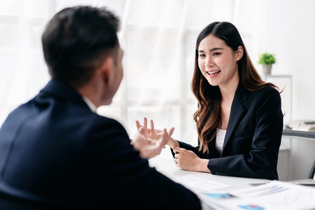 Business teamwork concept, Business colleague are collaboration presenting to brainstorming and discussing about strategy of new startup while holding finance paperwork and meeting together in office.の写真素材