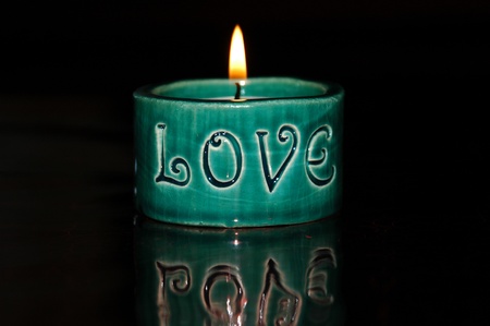 Burning candle with the word Love writtenの写真素材