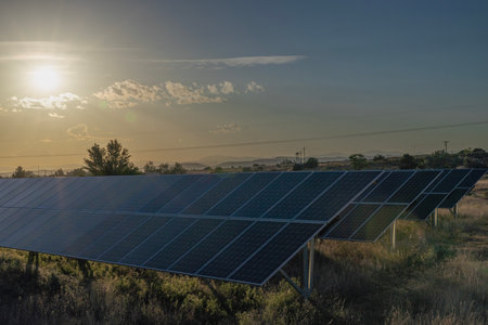 Solar panels with their backs to the setting sun in Santa Fe, NM.