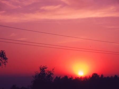 Sunset with the sky burning in pink, red and orange colorsの写真素材