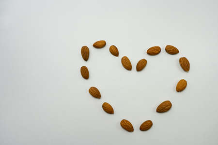 heart of almonds on a white background top viewの写真素材