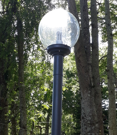 a light fixture amidst nature, reflecting sunlightの写真素材