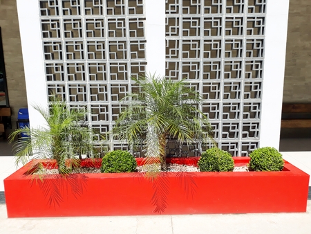 flowerbed whimsically cared for alongside a beautiful wall panelの写真素材