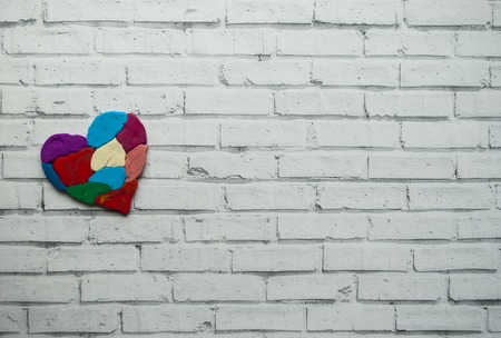 Autism awareness concept with colorful heart made of pieces of modeling clay on white background with text space.の写真素材